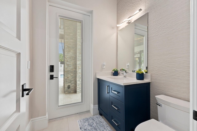 bathroom featuring vanity, tile patterned floors, and toilet