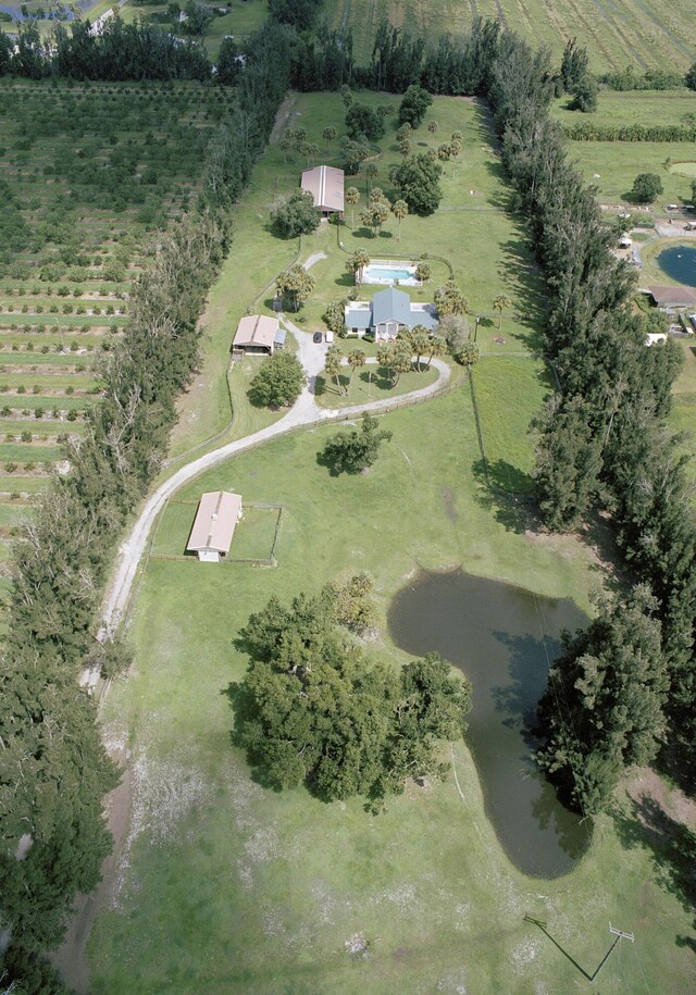 birds eye view of property with a rural view and a water view