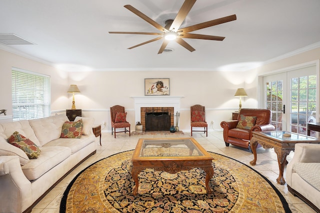 tiled living room with ceiling fan, a brick fireplace, crown molding, and plenty of natural light