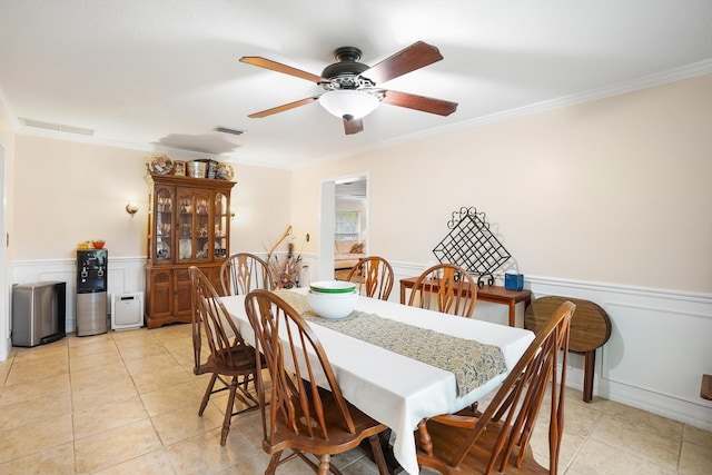 dining room featuring light tile patterned floors, ceiling fan, and ornamental molding