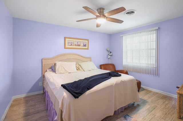 bedroom with ceiling fan and light hardwood / wood-style floors