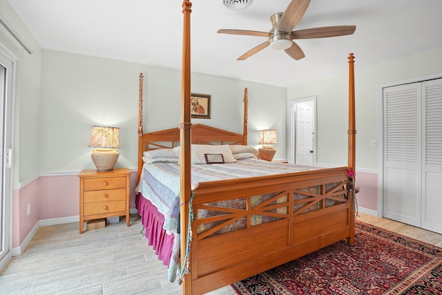 bedroom with ceiling fan, a closet, and light hardwood / wood-style flooring