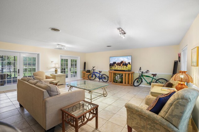 living room featuring light tile patterned floors and french doors