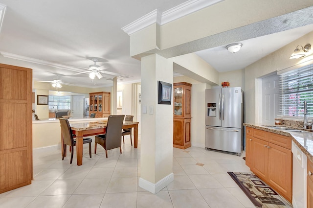 kitchen with stainless steel refrigerator with ice dispenser, crown molding, dishwasher, and sink