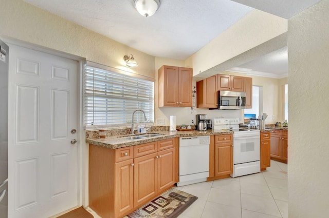 kitchen featuring sink, ornamental molding, light tile patterned floors, light stone counters, and white appliances