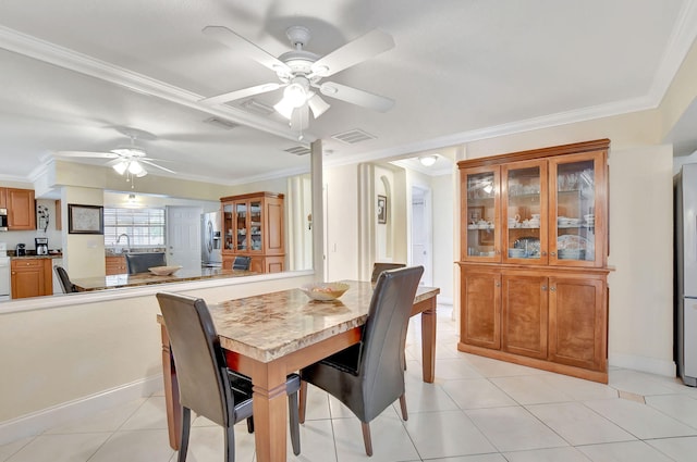 dining space featuring crown molding, ceiling fan, and light tile patterned floors