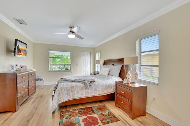 bedroom featuring multiple windows, ornamental molding, light wood-type flooring, and ceiling fan