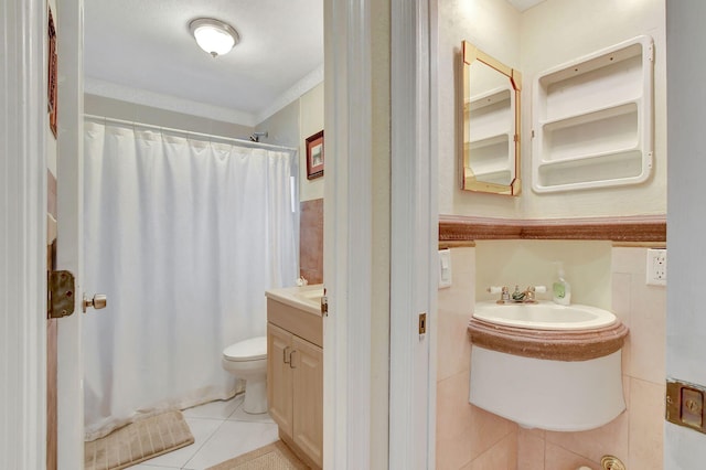 bathroom featuring tile walls, tile patterned flooring, vanity, toilet, and crown molding