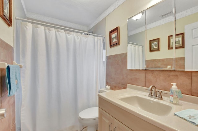 bathroom with a shower with curtain, vanity, toilet, and tile walls