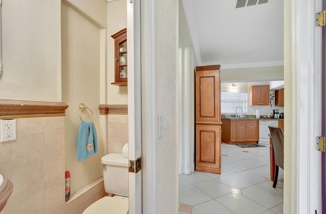 bathroom with ornamental molding, vanity, tile patterned floors, and toilet