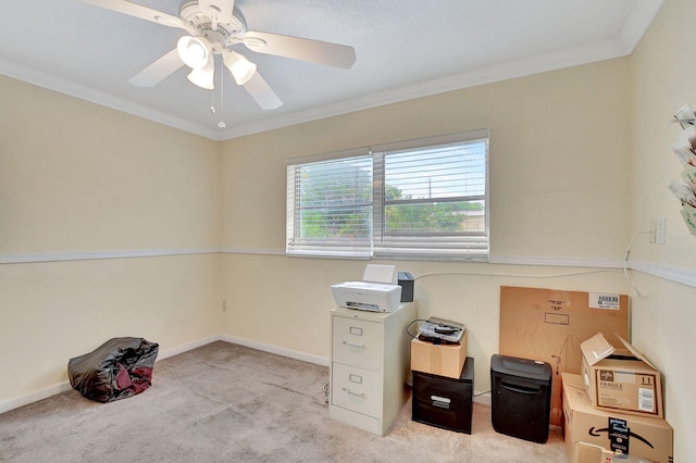 carpeted home office featuring crown molding and ceiling fan