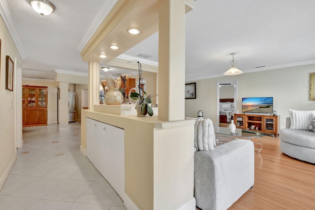 living room featuring ornamental molding and light tile patterned flooring