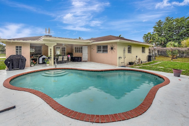 view of pool with grilling area and a patio area