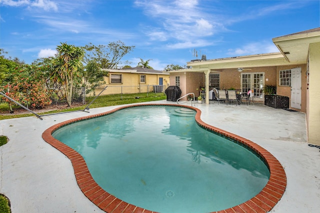 view of swimming pool featuring ceiling fan and a patio