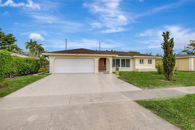 ranch-style home with a garage and a front lawn