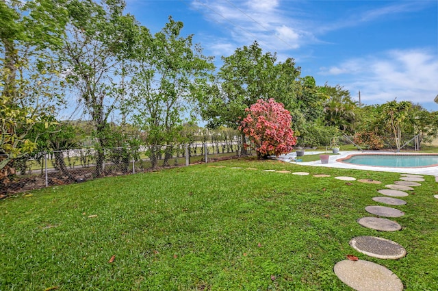 view of yard with a fenced in pool