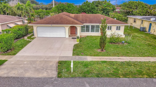 ranch-style home featuring a garage, central AC, and a front yard