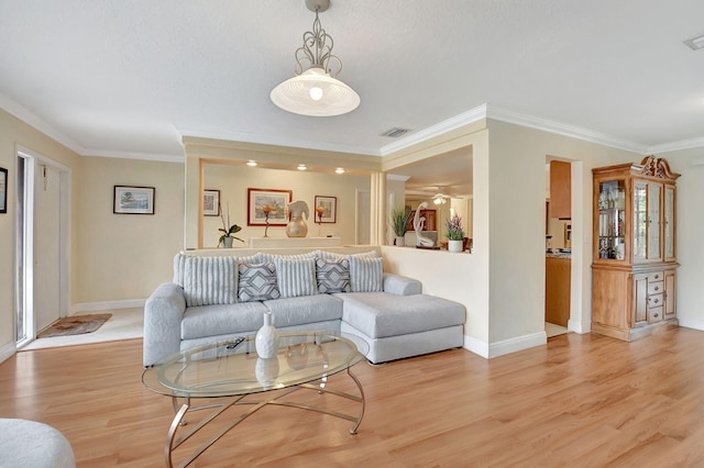 living room featuring crown molding and light wood-type flooring