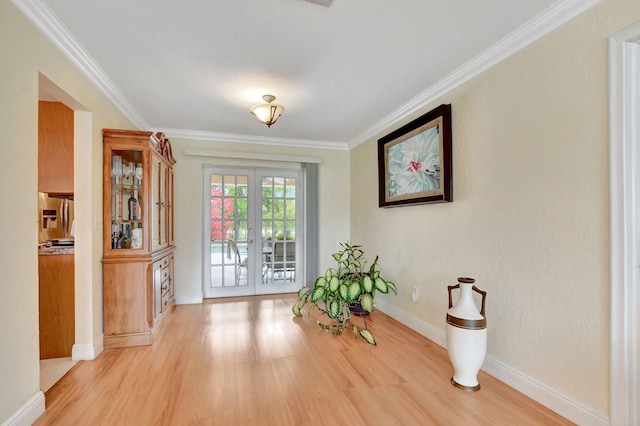 doorway to outside with french doors, ornamental molding, and light hardwood / wood-style flooring