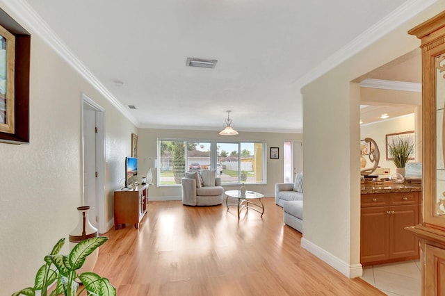 living room featuring light hardwood / wood-style flooring and ornamental molding