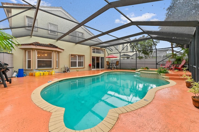 view of pool with an in ground hot tub, a lanai, and a patio area