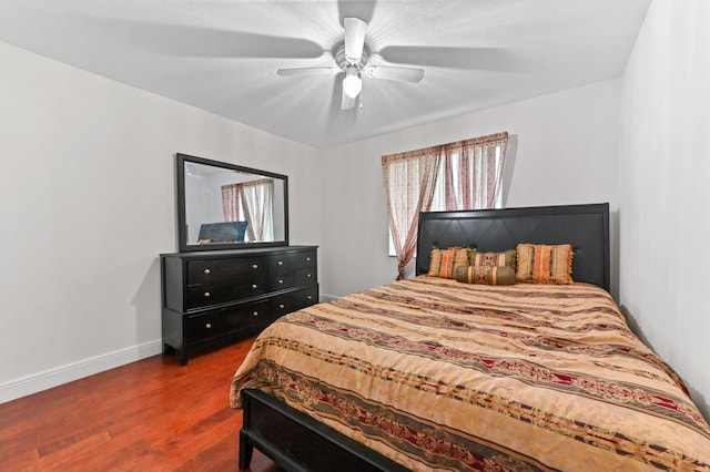 bedroom with dark wood-type flooring and ceiling fan