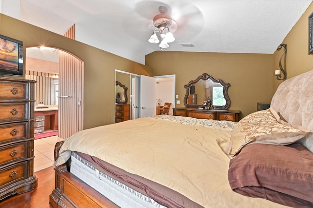 bedroom with ceiling fan, dark hardwood / wood-style floors, and vaulted ceiling