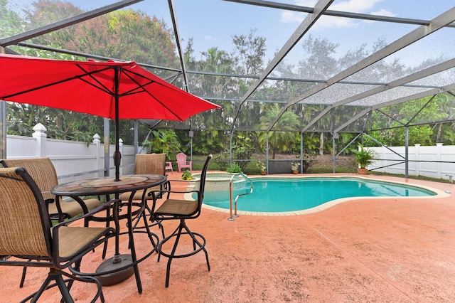 view of swimming pool with a lanai and a patio area