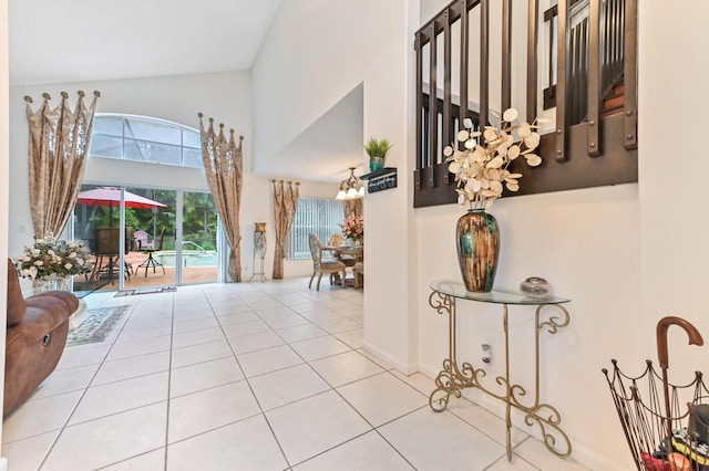 entryway with light tile patterned floors and a chandelier