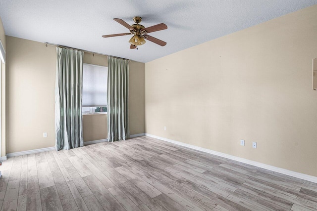 spare room featuring light hardwood / wood-style floors, a textured ceiling, and ceiling fan