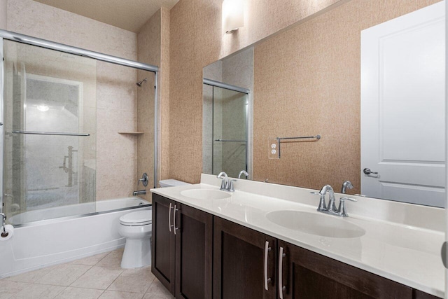 full bathroom with vanity, toilet, combined bath / shower with glass door, and tile patterned flooring