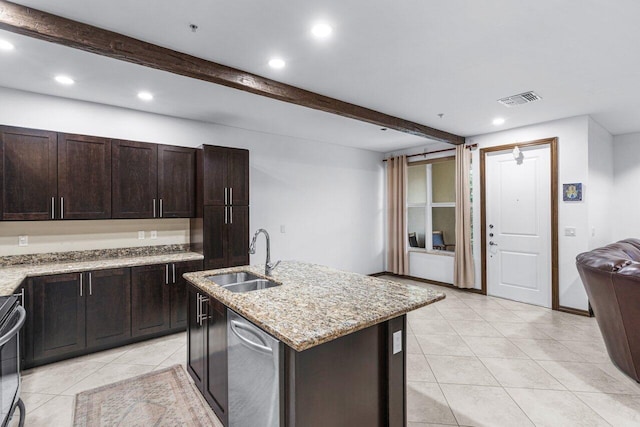 kitchen featuring beamed ceiling, light stone countertops, dishwasher, sink, and a center island with sink