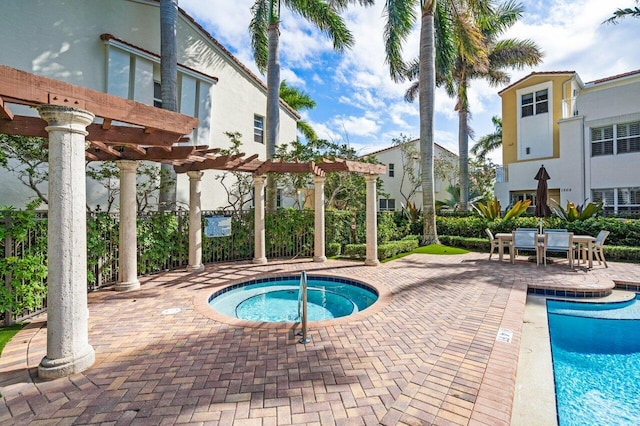 view of swimming pool with a community hot tub, a patio, and a pergola