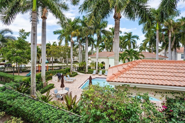 surrounding community featuring a pool and a patio area