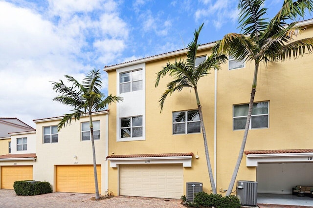 view of front facade with a garage and central AC unit