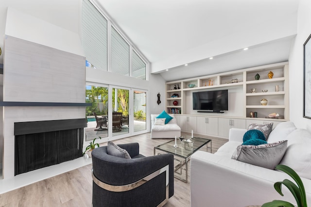 living room featuring light hardwood / wood-style flooring and a towering ceiling