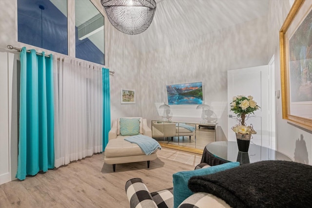 living area with hardwood / wood-style flooring and high vaulted ceiling