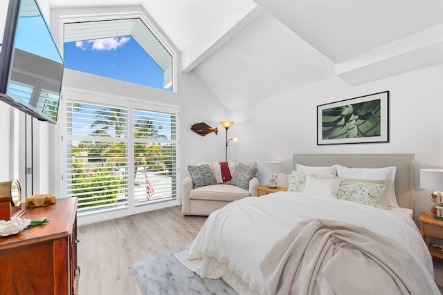 bedroom with light hardwood / wood-style floors, high vaulted ceiling, and beam ceiling