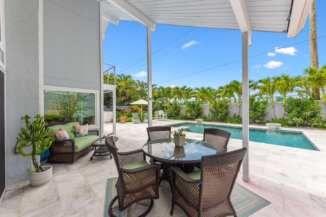 view of patio with an outdoor living space and a fenced in pool