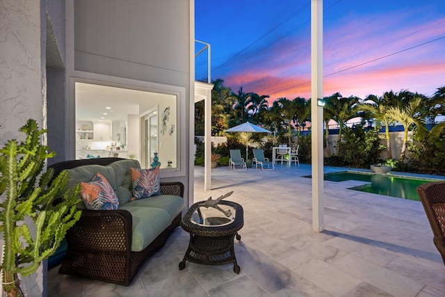 patio terrace at dusk with a fenced in pool and outdoor lounge area