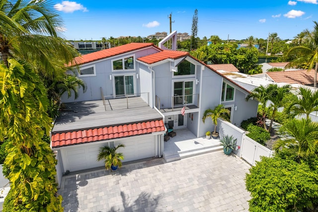 view of front of house featuring a balcony and a garage