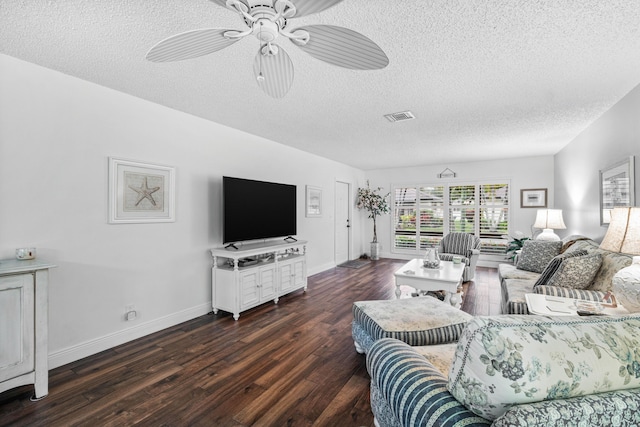 living room with dark wood-type flooring, a textured ceiling, and ceiling fan