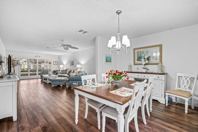 dining space featuring a textured ceiling, ceiling fan with notable chandelier, and dark hardwood / wood-style floors