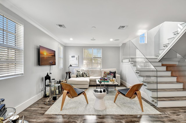 living room featuring dark hardwood / wood-style flooring and crown molding