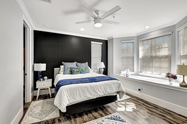 bedroom with ceiling fan, wood-type flooring, and ornamental molding