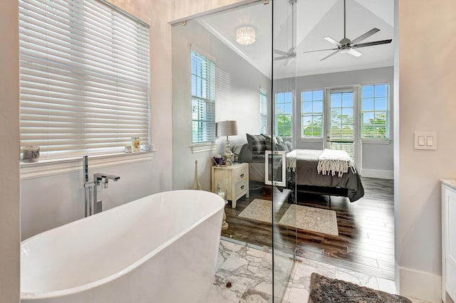 bathroom with crown molding, a bath, vaulted ceiling, and vanity