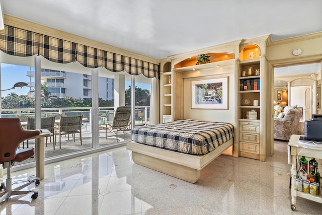 bedroom with ornamental molding and access to exterior