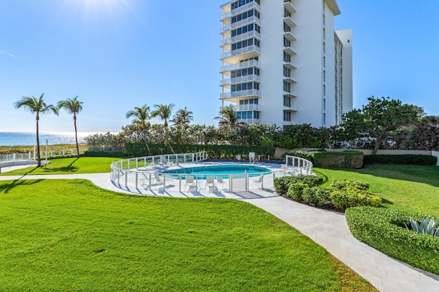 view of swimming pool with a lawn