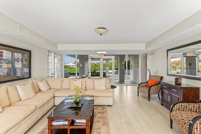 living room featuring light hardwood / wood-style flooring and french doors