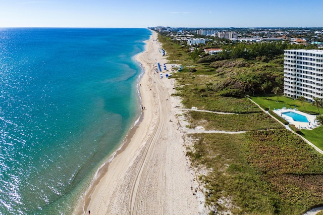 drone / aerial view with a water view and a view of the beach